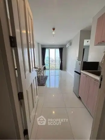 Spacious modern apartment with open layout and city view, featuring sleek kitchen and dining area.
