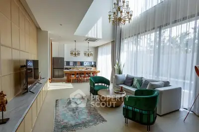 Luxurious living room with high ceilings, elegant chandeliers, and modern furniture in a spacious open layout.