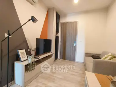 Modern living room with stylish decor and cozy ambiance, featuring a sleek TV unit and comfortable seating.