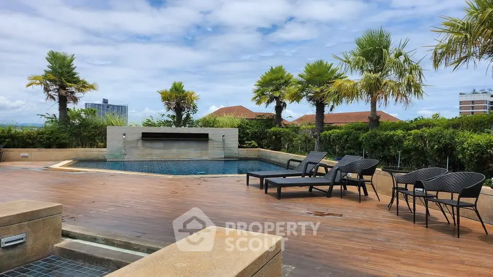 Luxurious rooftop pool with stunning city views and palm trees, perfect for relaxation and leisure.