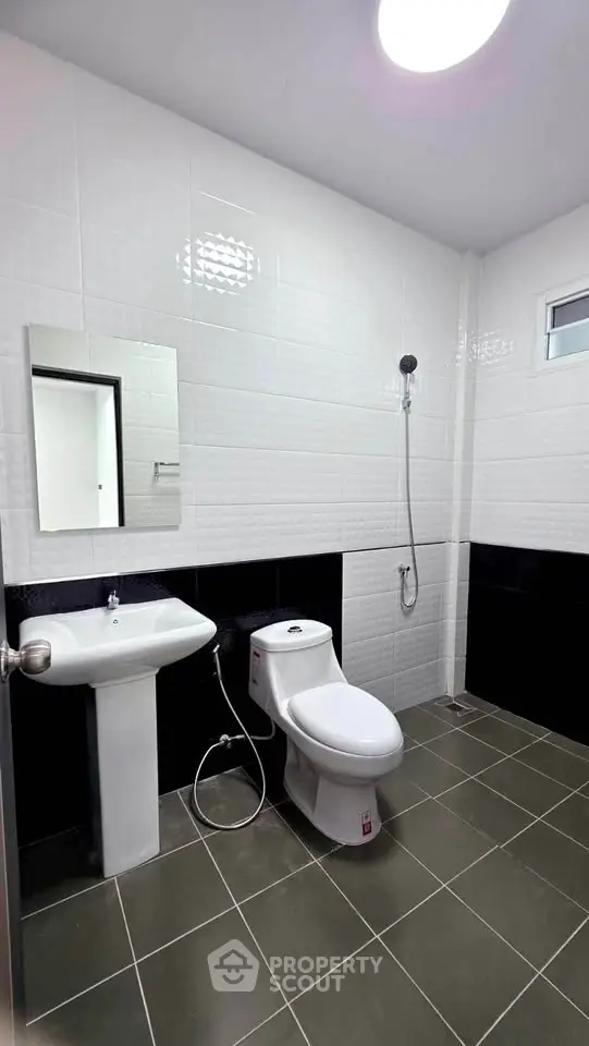 Modern bathroom with sleek white tiles and contemporary fixtures