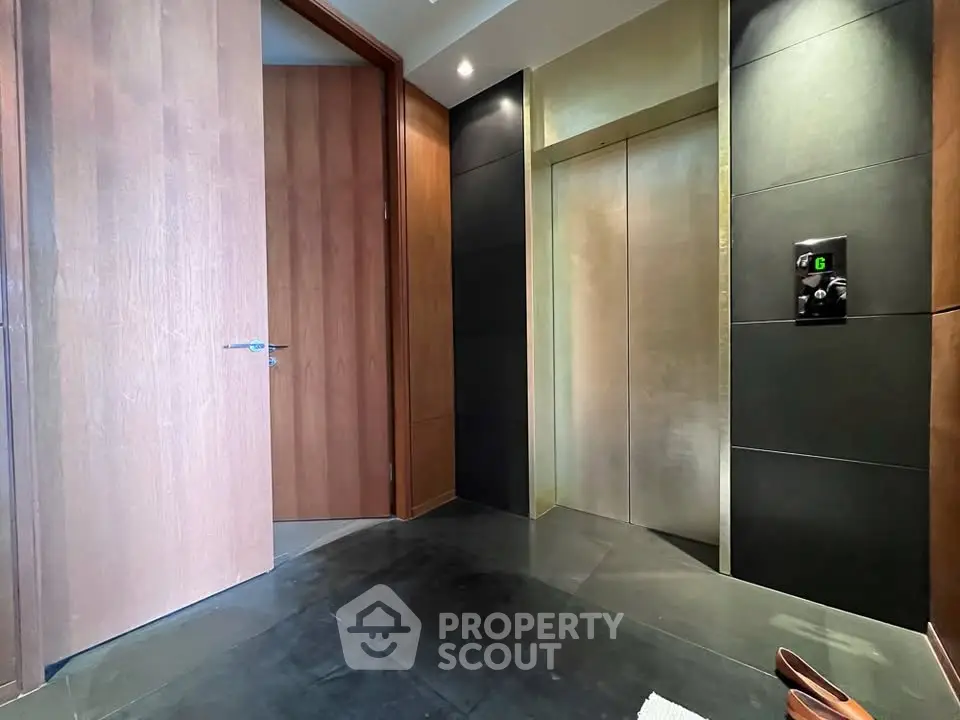 Luxurious modern elevator lobby with sleek design and wooden accents