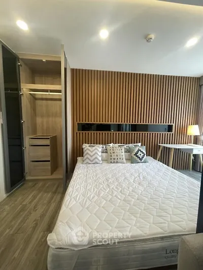 Modern bedroom with stylish wood paneling and cozy decor
