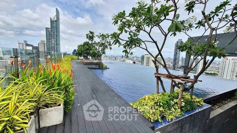Stunning rooftop infinity pool with panoramic city views and lush greenery.