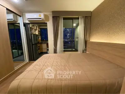 Modern bedroom with balcony view in high-rise apartment, featuring cozy lighting and stylish decor.