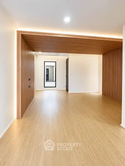 Spacious modern living room with wooden flooring and elegant lighting