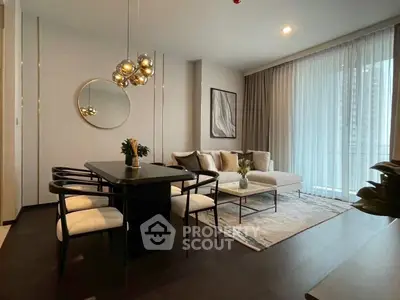 Modern living room with elegant decor, featuring a stylish dining area and large windows for natural light.