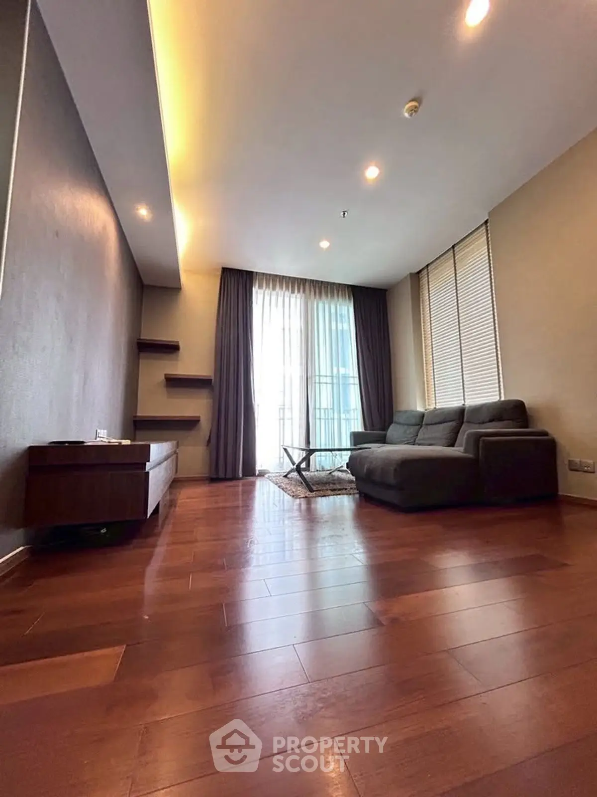Spacious modern living room with wooden flooring and large windows