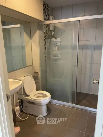 Modern bathroom with glass shower and sleek tile design