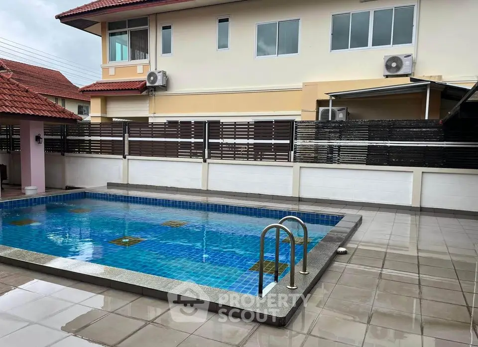 Spacious residential property with private swimming pool and modern exterior design.