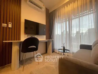 Modern living room with sleek furniture and large window view