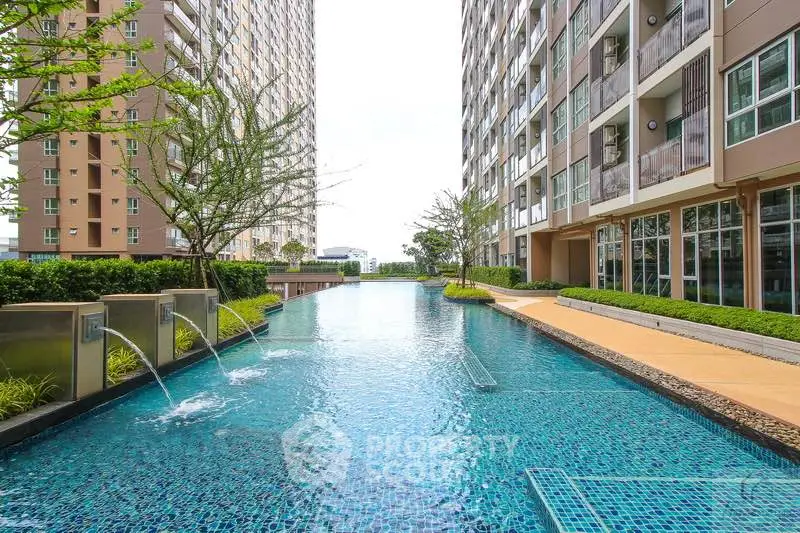 Luxurious apartment complex with stunning pool and modern architecture.
