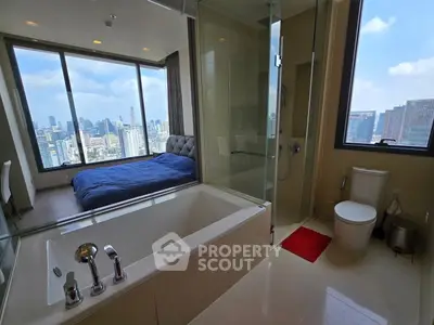 Luxurious bedroom with city view and modern ensuite bathroom featuring a bathtub.