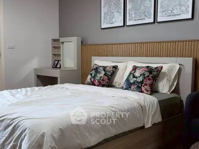 Cozy bedroom with stylish decor and floral pillows, perfect for relaxation and comfort.
