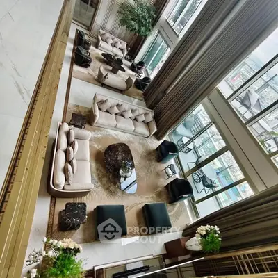 Luxurious high-ceiling living room with elegant furniture and panoramic city views.