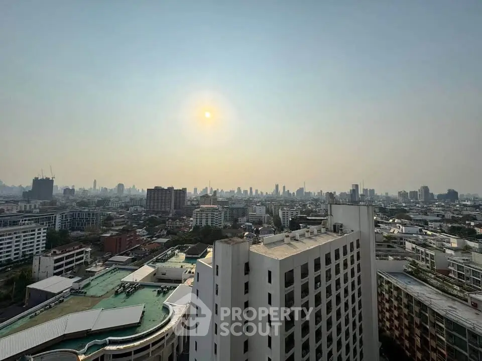 Stunning cityscape view from high-rise building at sunset, showcasing urban skyline and vibrant city life.