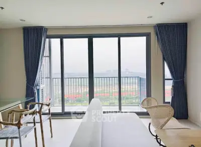 Spacious living room with large windows and stunning balcony view