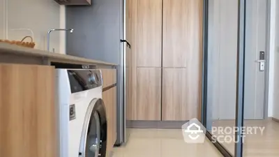 Modern kitchen with sleek appliances and wooden cabinetry