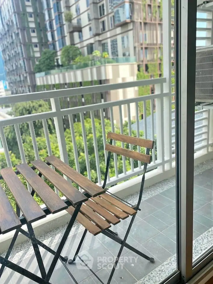 Charming balcony with wooden furniture and city view, perfect for relaxation and enjoying urban living.