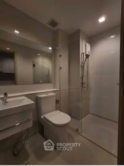 Modern bathroom with sleek fixtures and glass shower enclosure