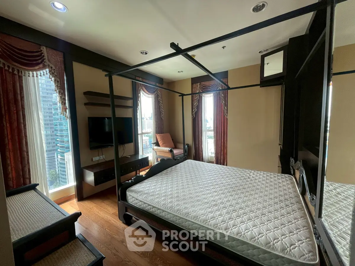 Luxurious bedroom with elegant decor and city view, featuring a stylish four-poster bed and modern amenities.