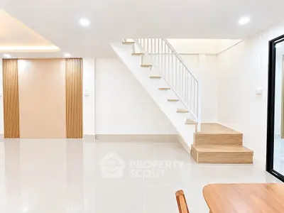 Modern minimalist interior with sleek staircase and open living space, perfect for contemporary living.