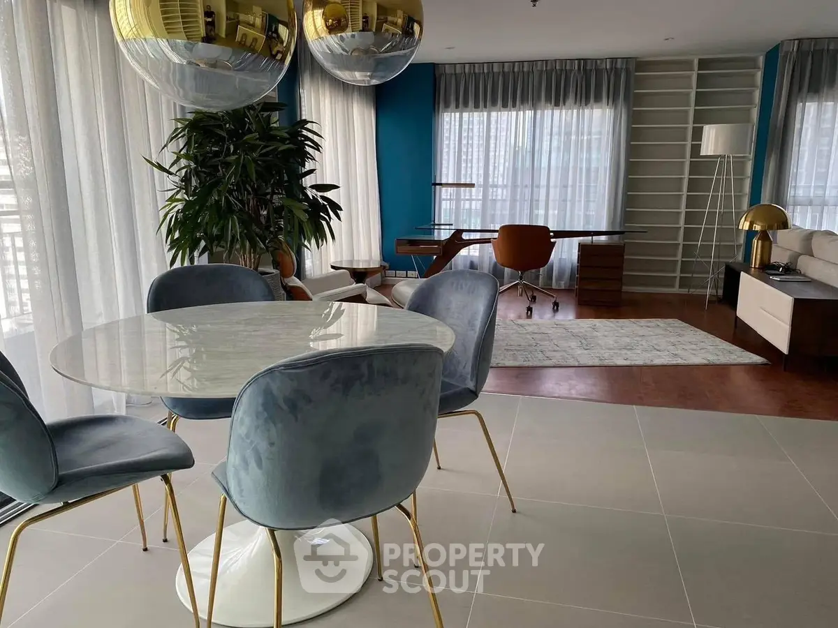Modern open-plan living room with stylish dining area and study corner