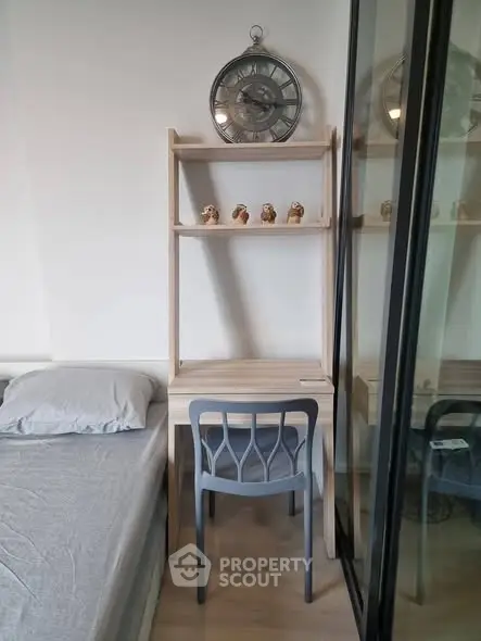 Modern bedroom with stylish study nook and decorative clock