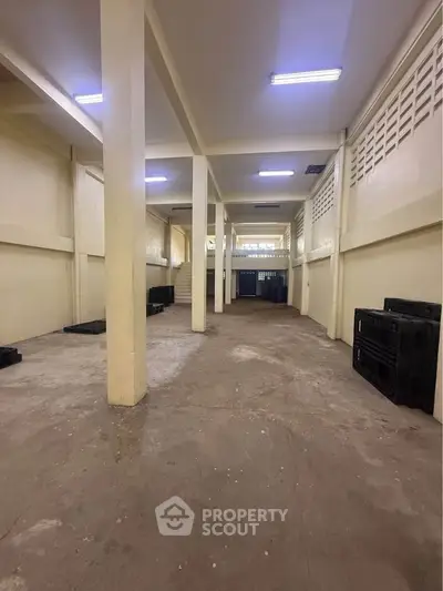 Spacious industrial warehouse with high ceilings and ample storage space.