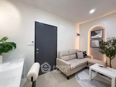 Modern living room with stylish decor and cozy seating area, perfect for relaxation and entertaining.