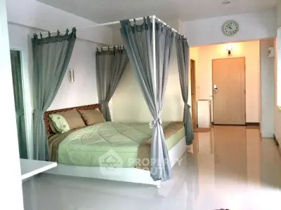 Spacious bedroom with elegant canopy bed and modern decor