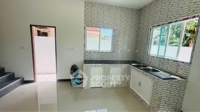 Modern kitchen with sleek countertops and stylish backsplash in a bright, airy space.