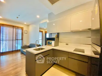Modern kitchen with sleek cabinetry and open layout in a stylish apartment