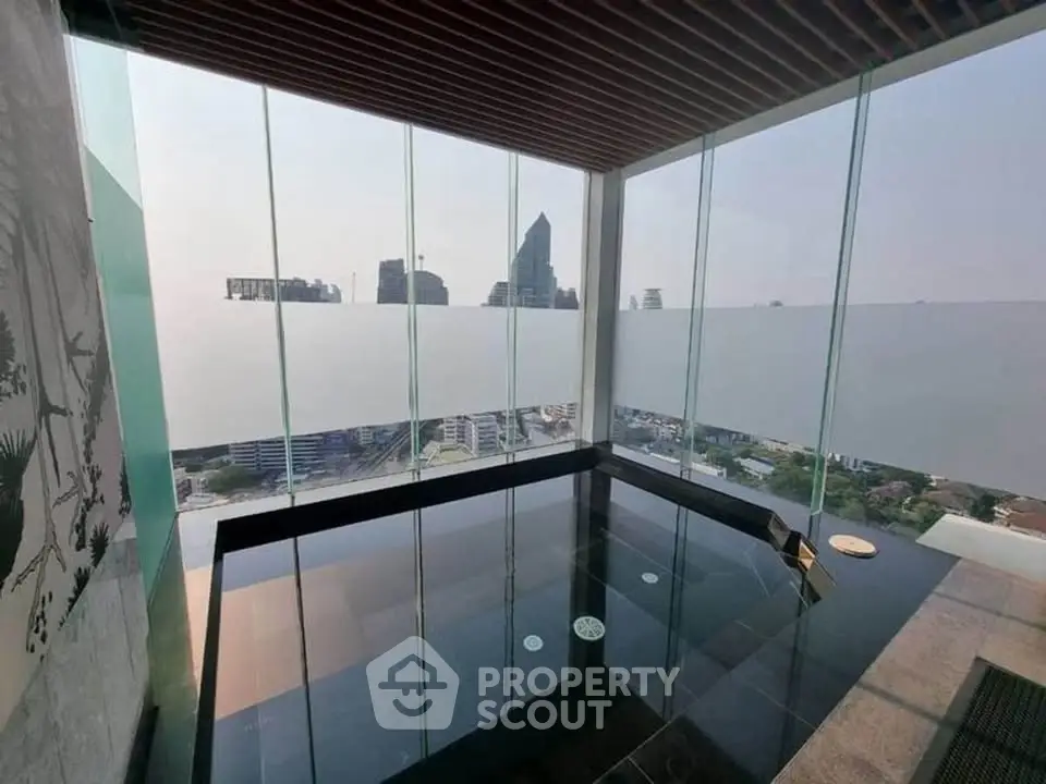 Luxurious rooftop pool with stunning city skyline view, perfect for relaxation and entertainment.