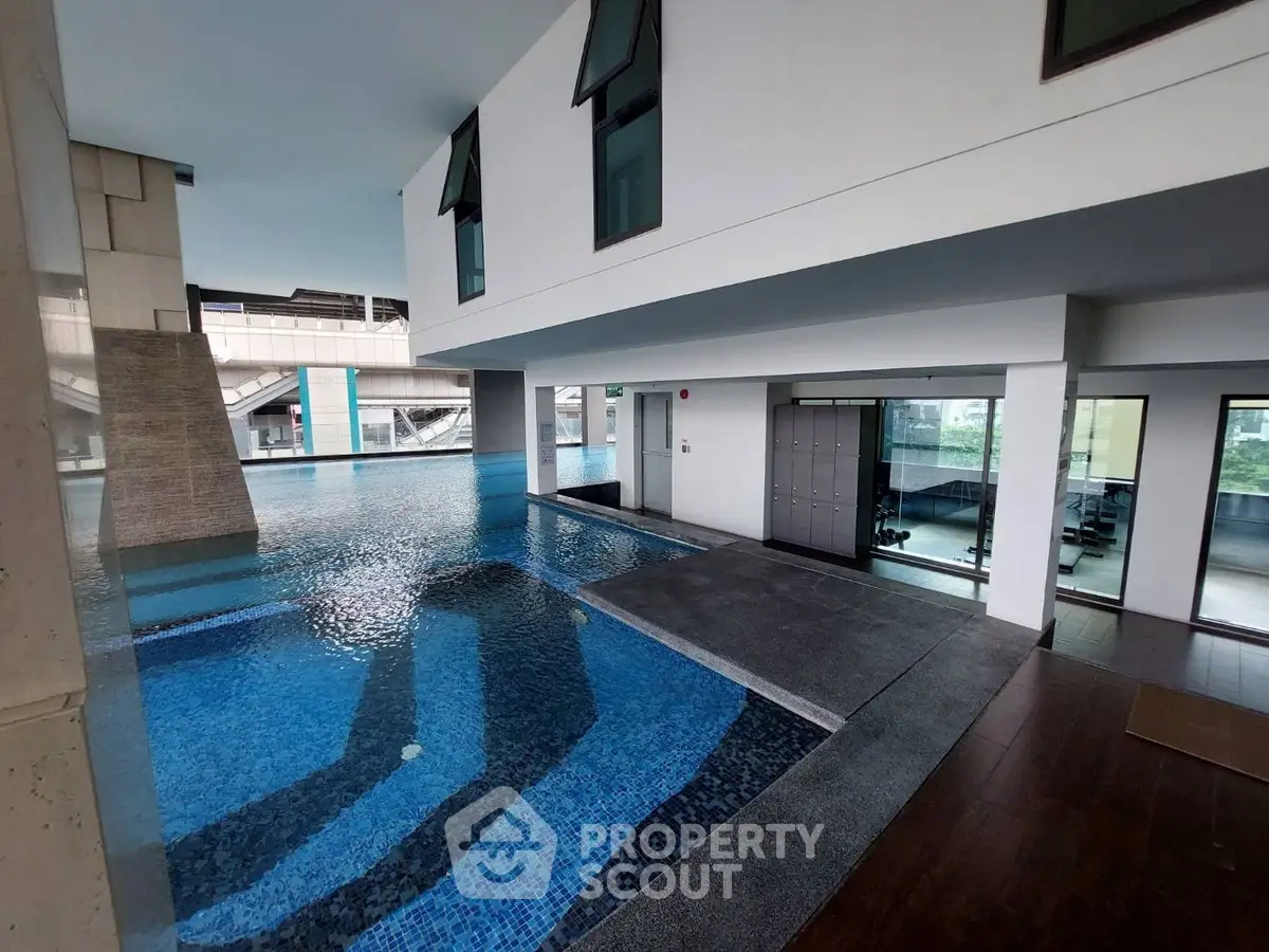 Luxurious indoor pool area with modern architecture and sleek design, perfect for relaxation and leisure.