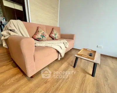 Cozy living room with stylish sofa and wooden coffee table on elegant flooring.