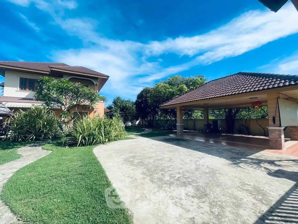 Spacious suburban home with lush garden and covered patio, perfect for outdoor living.
