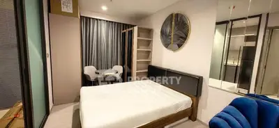 Modern bedroom with stylish decor and cozy seating area