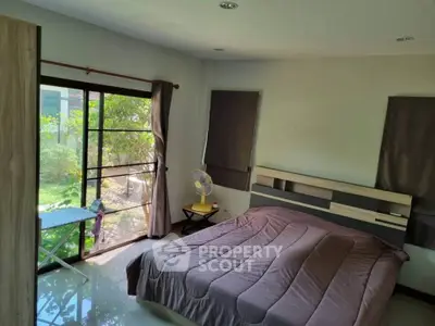 Cozy bedroom with garden view and modern furnishings