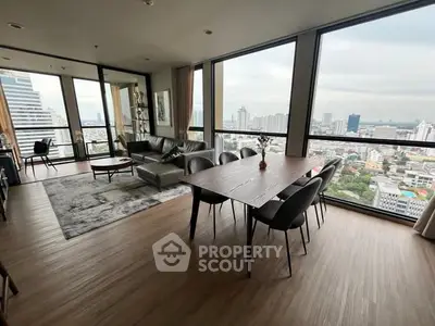 Spacious modern living room with panoramic city views and elegant dining area.