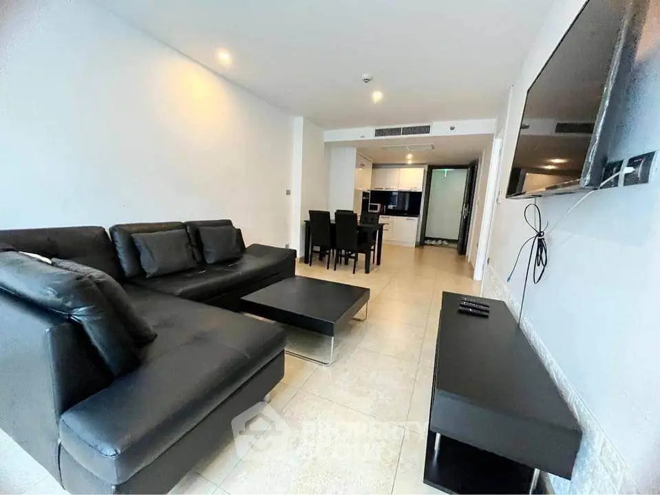 Spacious modern living room with sleek black furniture and open layout
