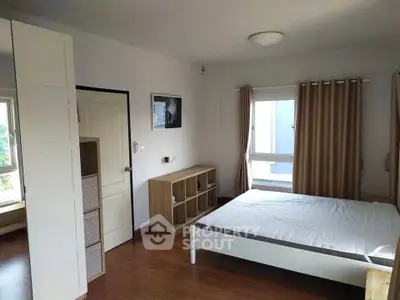 Spacious bedroom with modern decor and ample natural light