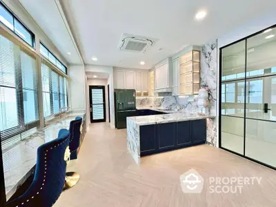 Luxurious modern kitchen with marble countertops and elegant seating