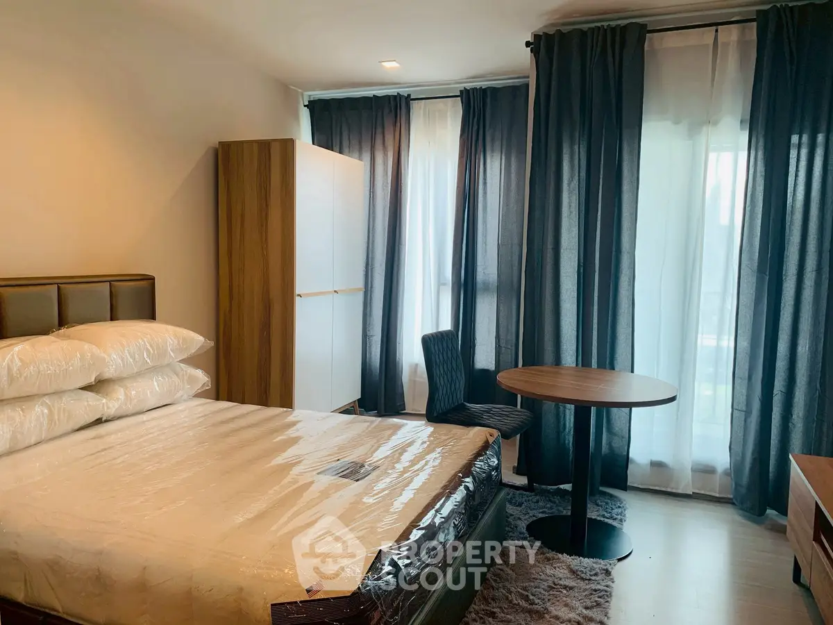 Cozy bedroom with modern furnishings and large windows for natural light