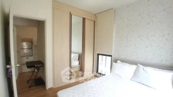 Cozy bedroom with mirrored wardrobe and natural light