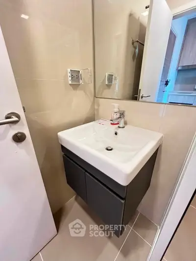 Modern bathroom with sleek sink and cabinet in a compact space