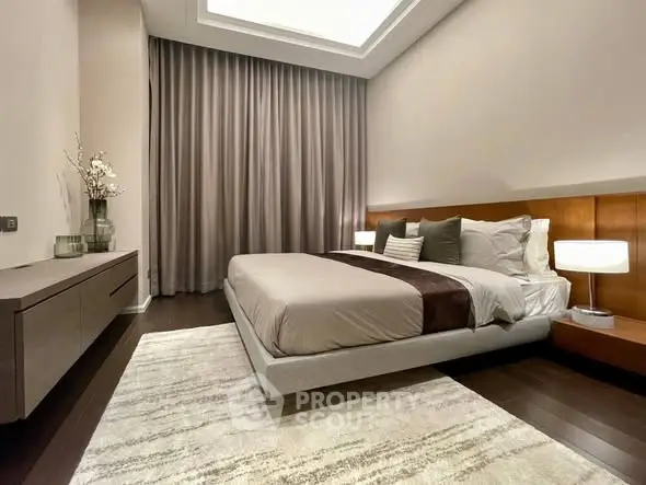Luxurious modern bedroom with elegant decor and ambient lighting, featuring a plush bed and stylish furnishings.
