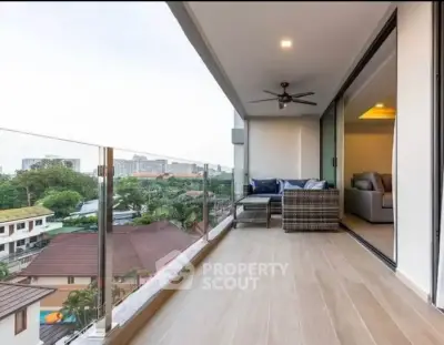 Spacious balcony with modern glass railing and scenic view