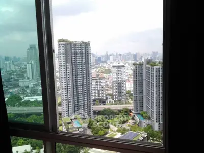 Stunning cityscape view from high-rise apartment window, showcasing modern urban living.