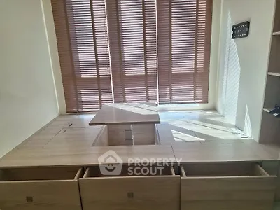 Modern study room with built-in wooden desk and storage, featuring elegant blinds for natural light control.